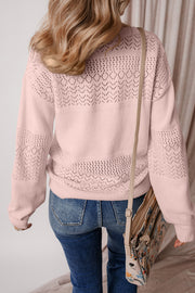 Perforated knit v-neck pullover sweater in dusty pink with allover eyelet pattern and relaxed fit.