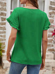 Green t-shirt with textured fabric and ruffled short sleeves.
