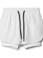 White layered performance shorts with perforated panels and a drawstring waist.