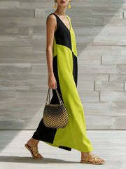 Geometric V-neck maxi dress in lime and black colorblock, sleeveless, with a flowing silhouette.