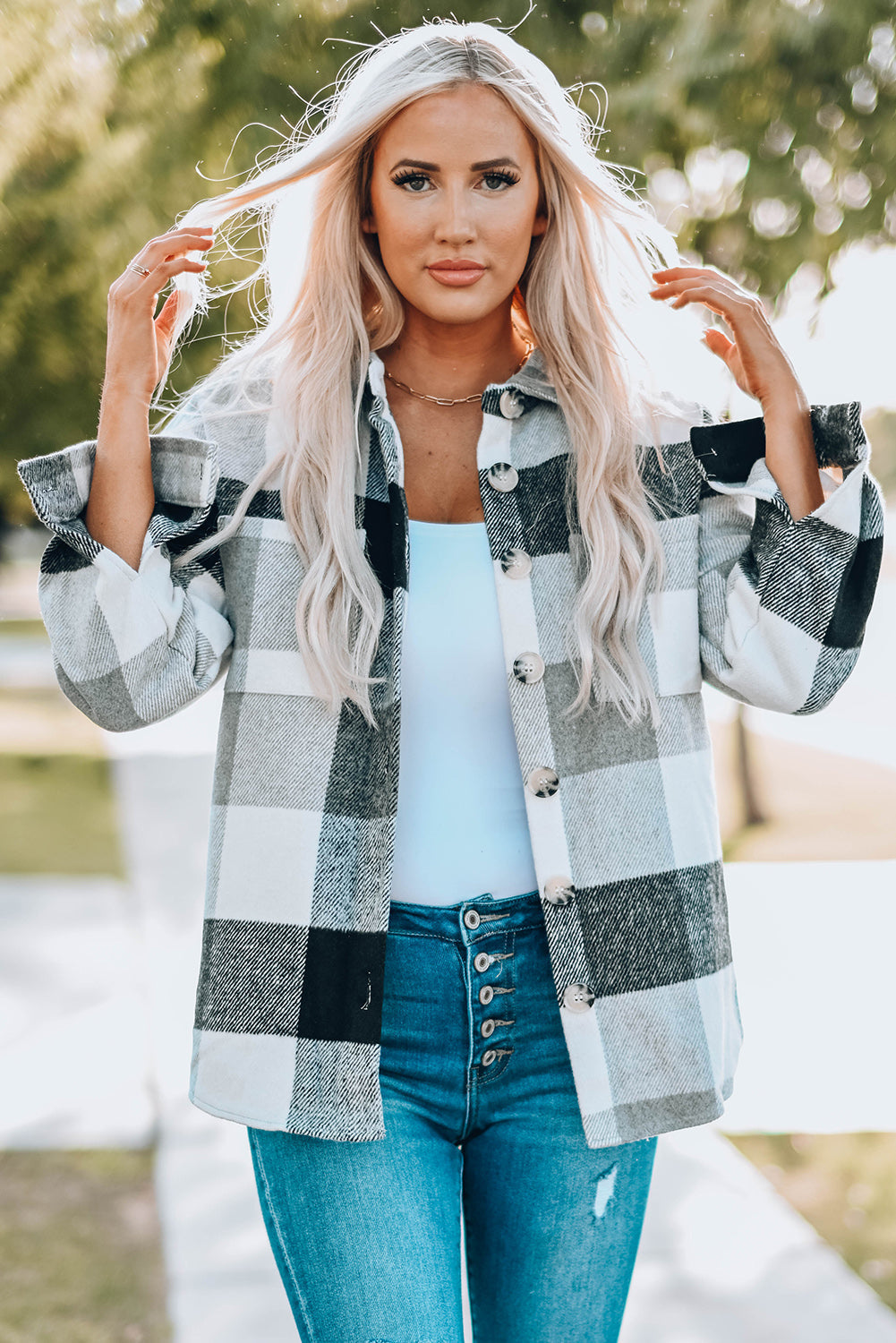 Oversized checkered shacket in light gray and black with button-down front and patch pocket.