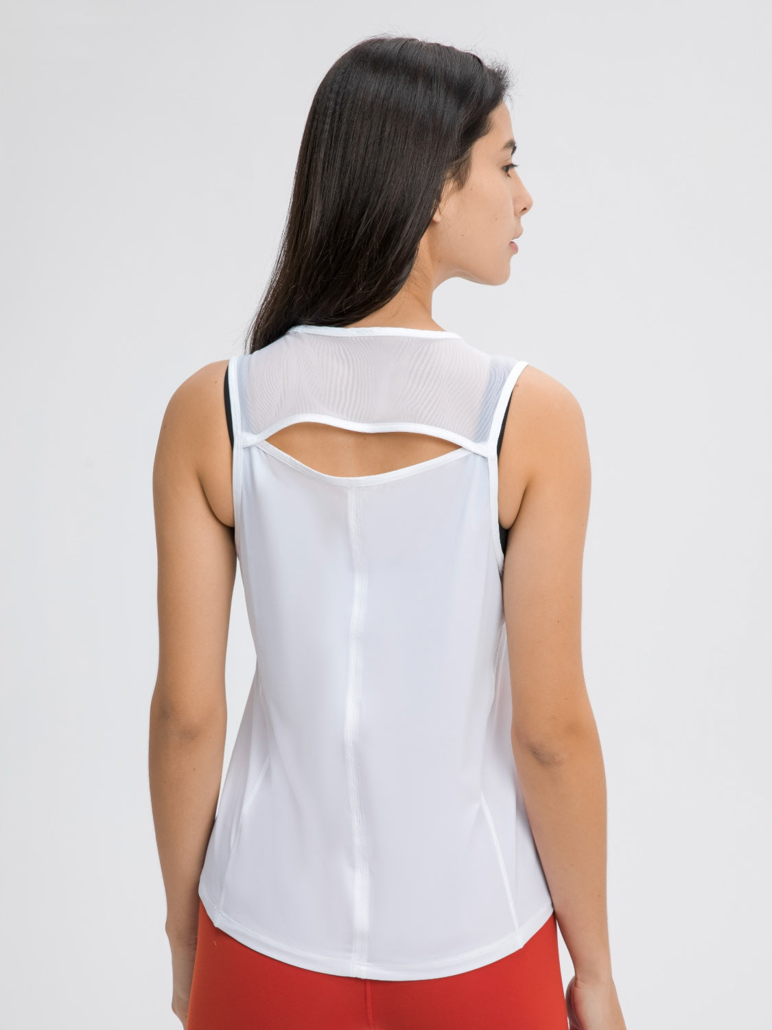 White mesh-back performance tank top with cutout detail and racerback style.
