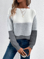 Colorblock boatneck knit sweater in gray, white, and black acrylic with long sleeves.