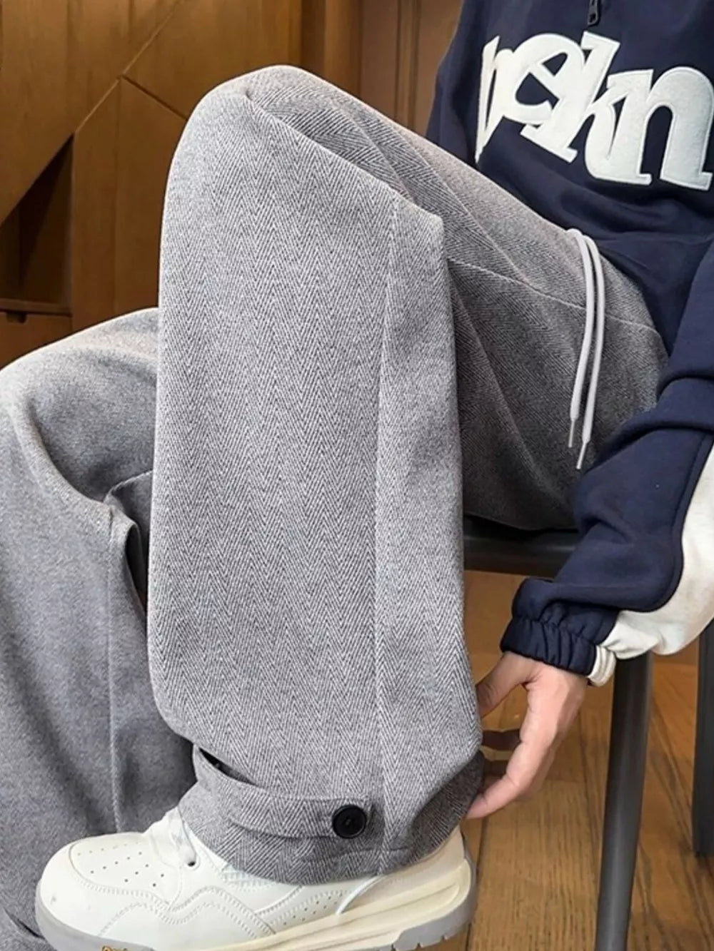 Relaxed fit grey herringbone sweatpants for men with drawstring and ankle cuff detail.