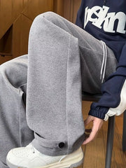 Relaxed fit grey herringbone sweatpants for men with drawstring and ankle cuff detail.