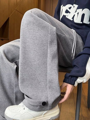 Relaxed fit grey herringbone sweatpants for men with drawstring and ankle cuff detail.