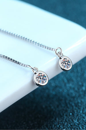 Silver moissanite threader earrings with a delicate chain and round cut stone.
