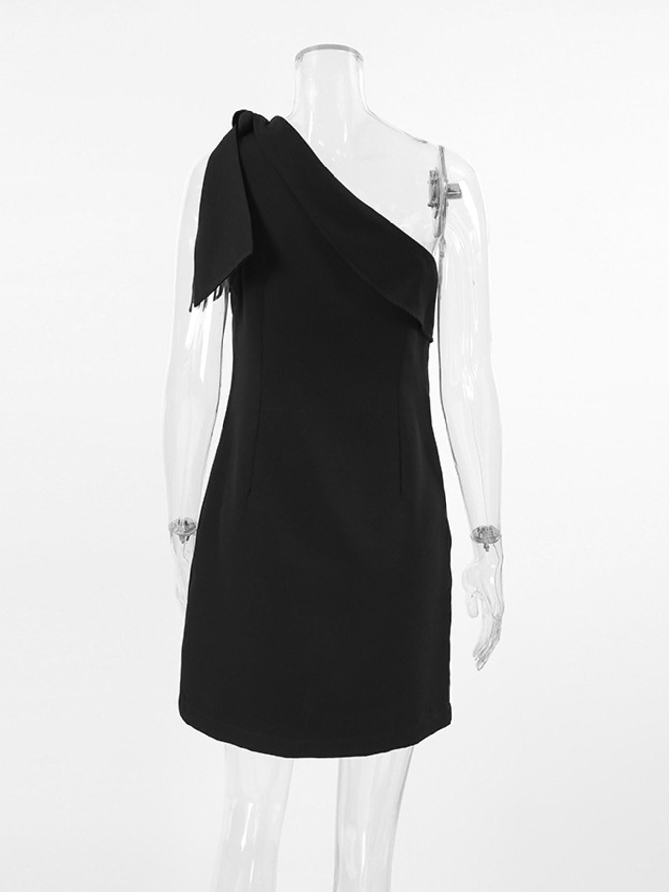 Black asymmetrical bow mini dress with one shoulder and frayed detail.