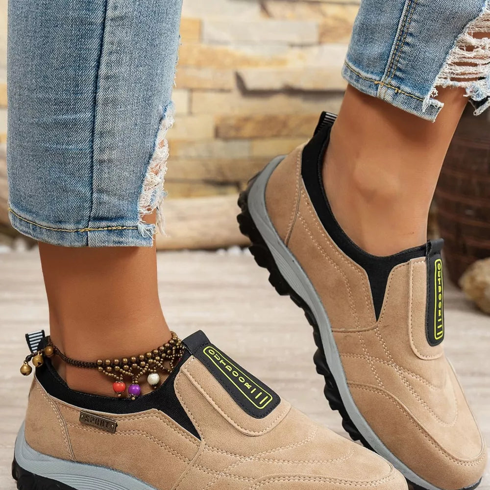 Khaki suede-like round toe slip-on sneakers with black trim and "OUTDOOR" detail.