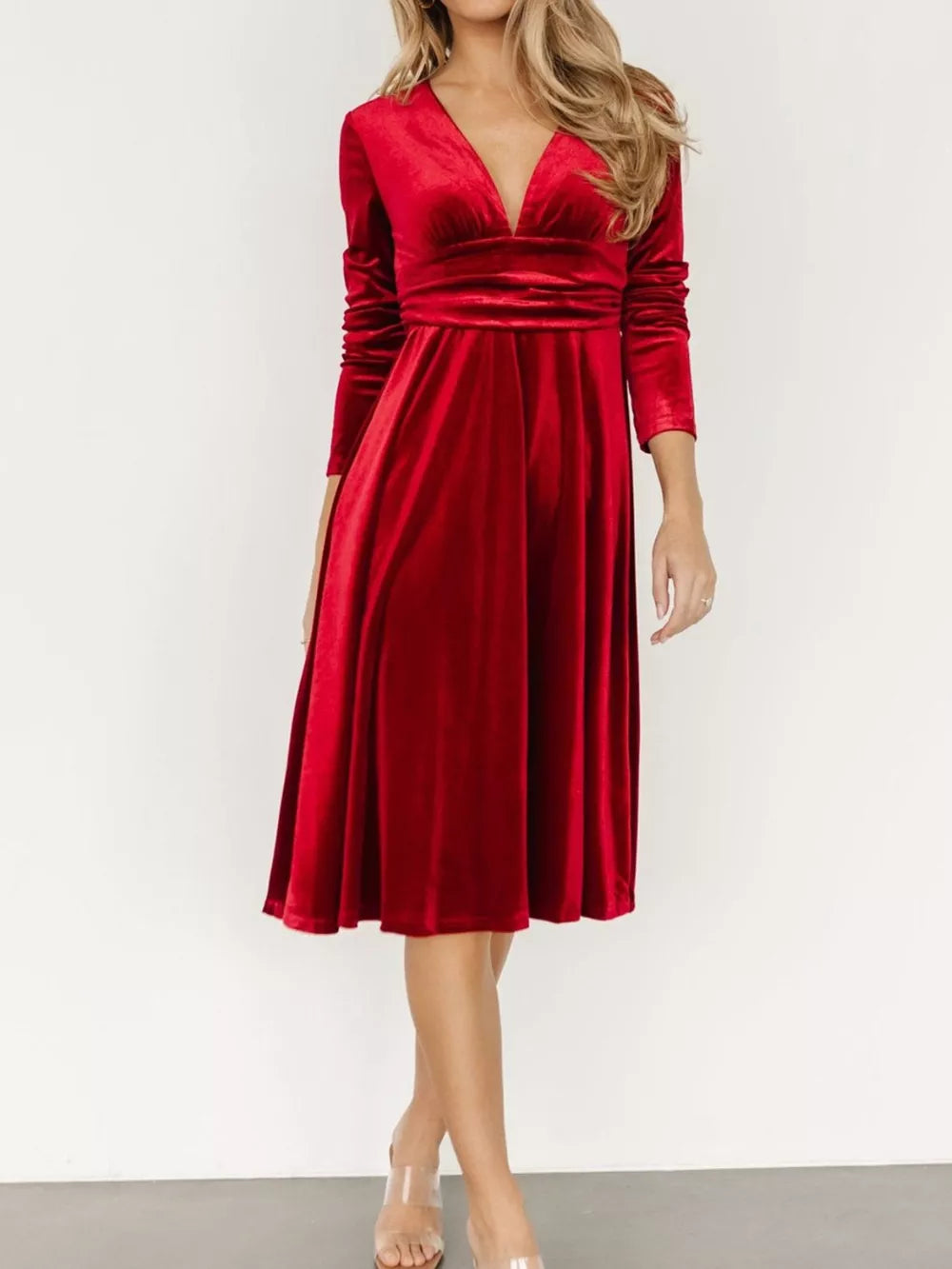 Red velvet midi dress with V-neck, long sleeves, and a-line skirt.