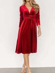 Red velvet midi dress with V-neck, long sleeves, and a-line skirt.
