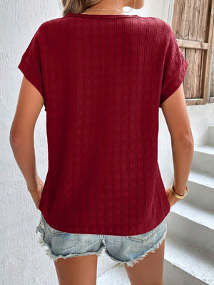 Burgundy woven texture cap-sleeve blouse with a relaxed fit.