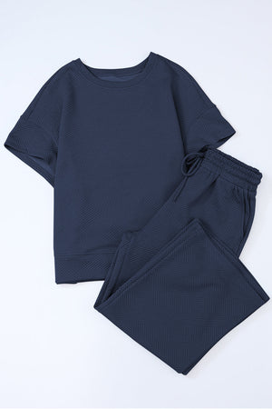 Dark blue textured knit tee and wide leg pants set with drawstring waist.