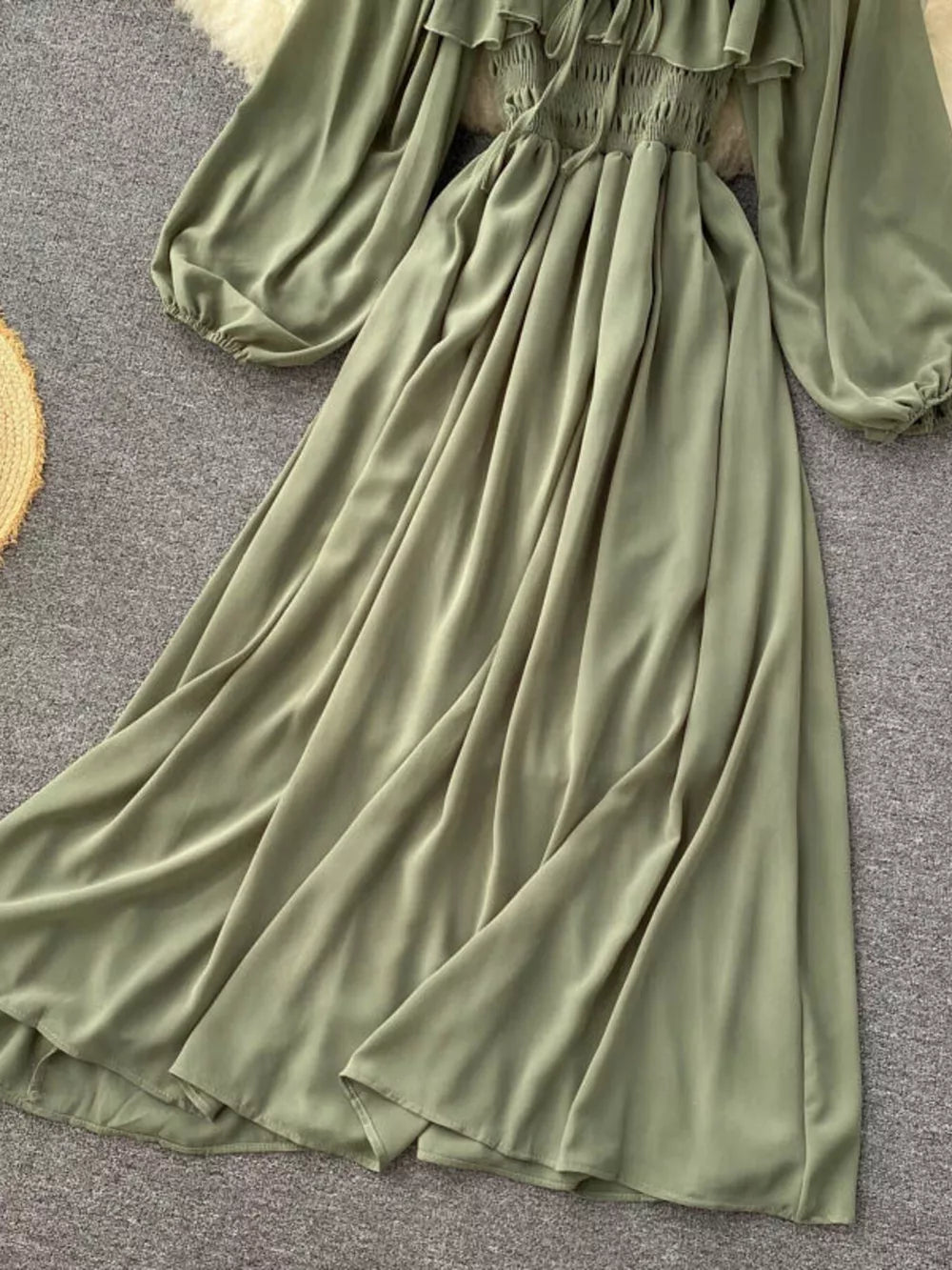 Green maternity dress with ruffled square neck, smocked bodice, balloon sleeves, and flowy A-line skirt.