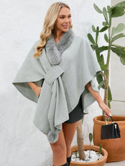 Gray faux fur collar wrap poncho with tie detail and pom-pom trim.