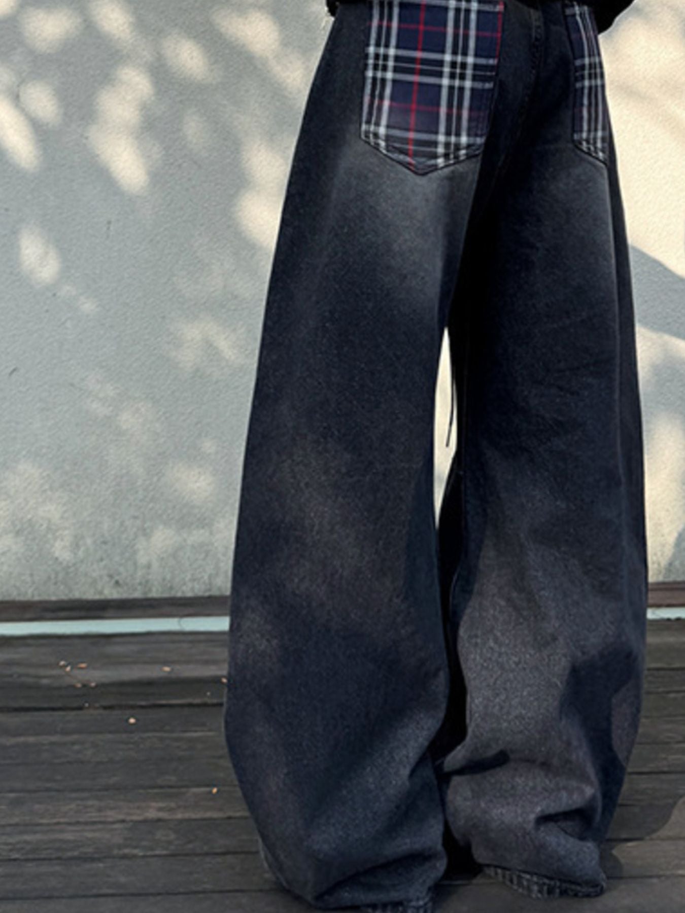 Men's dark grey vintage wash baggy jeans with plaid back pocket details.