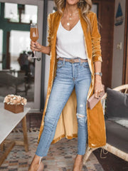 Velvet duster coat in tangerine with a fluid silhouette, open front, and long sleeves.