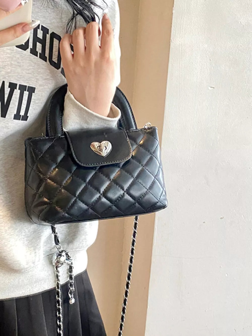 Quilted Heart Lock Crossbody Bag in Black, back view