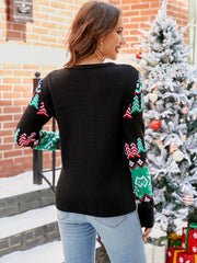 Black acrylic intarsia knit jumper with festive Christmas tree pattern on sleeves.