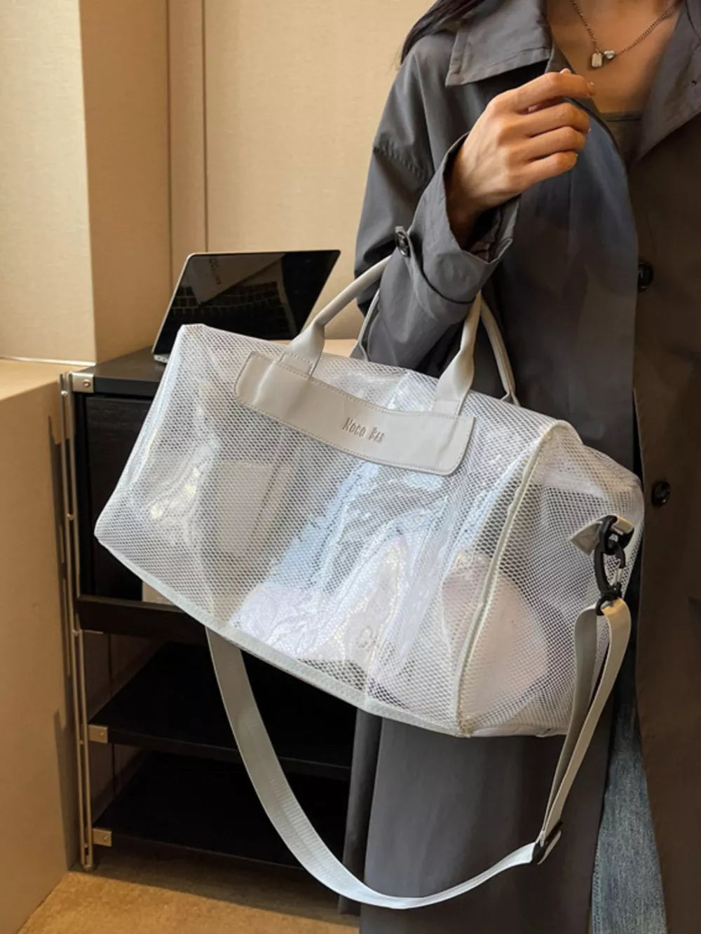 Vibrant transparent PVC mesh travel bag with light gray trim and strap.