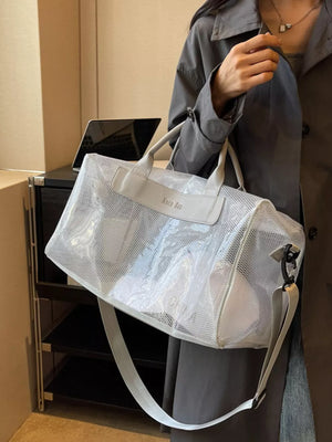 Vibrant transparent PVC mesh travel bag with light gray trim and strap.