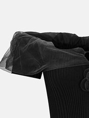 Black off-shoulder knit t-shirt with ruffled tulle trim and floral applique detail.