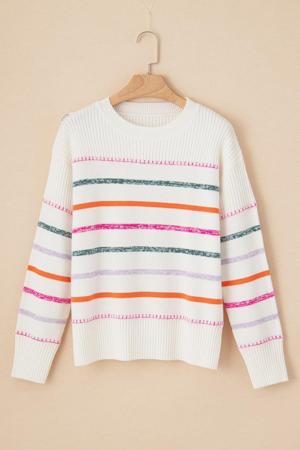 White ribbed knit pullover sweater with colorful stripes and crew neck.