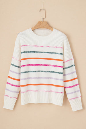 White ribbed knit pullover sweater with colorful stripes and crew neck.