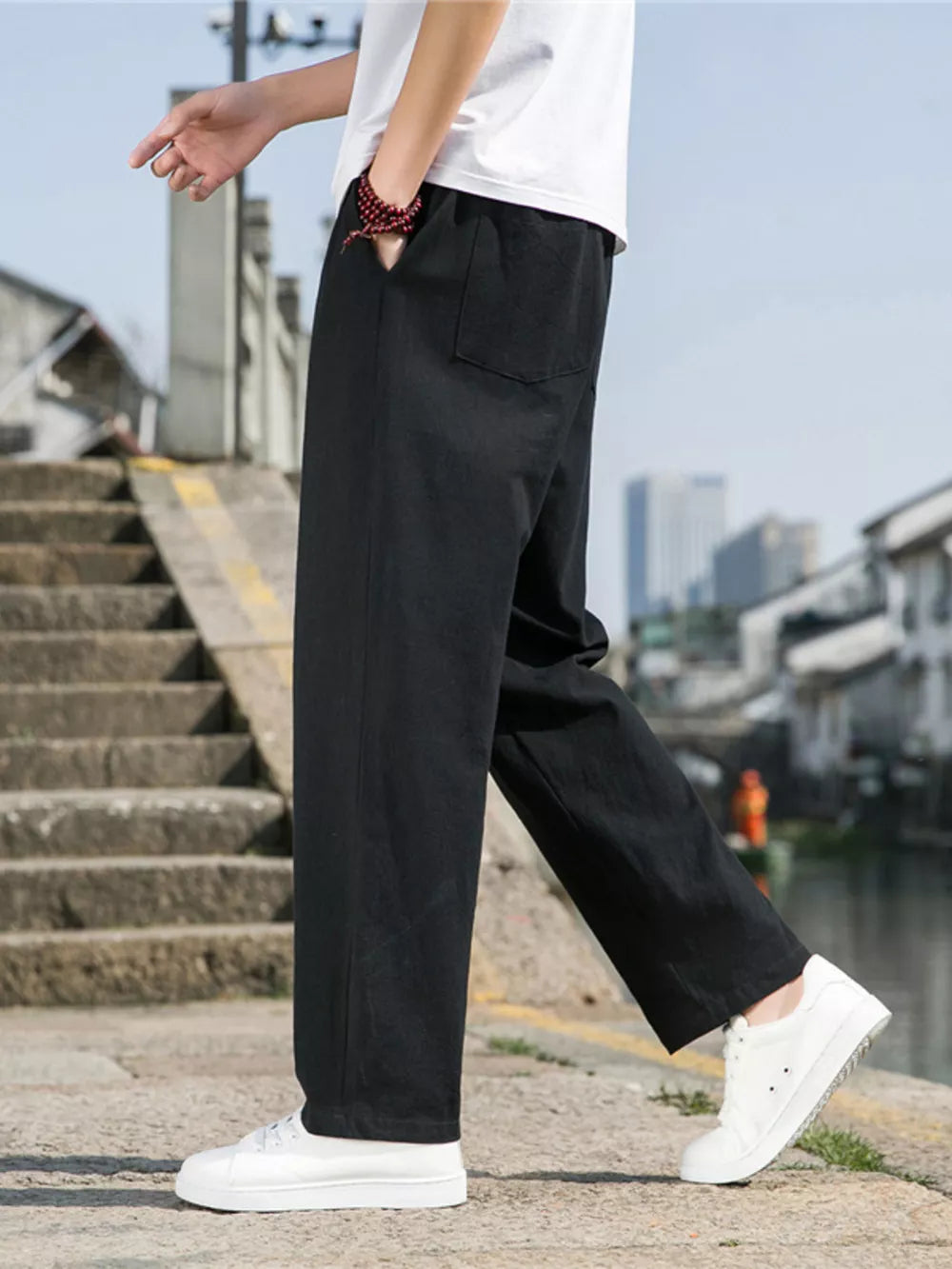 Men's black drawstring sweatpants with a relaxed fit and side pockets.