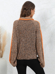 Colorblock raglan sleeve turtleneck knit sweater in brown and orange acrylic with orange sleeve stripes.