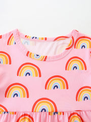 Toddler pink cotton blend dress with rainbow print and ruffled hem detail.