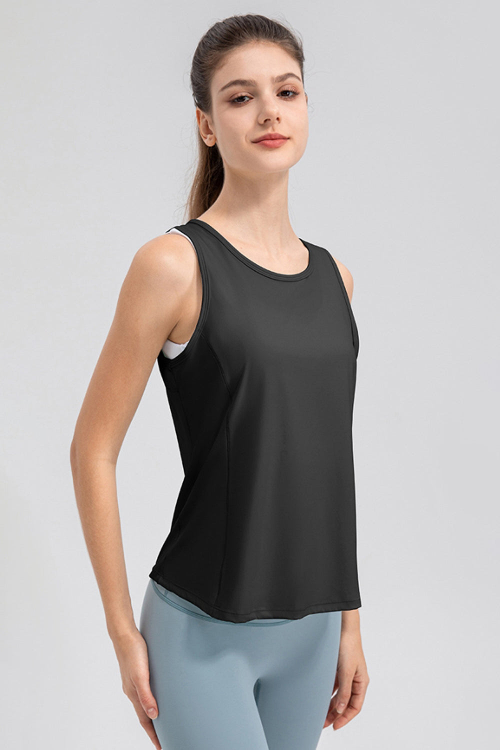 Black performance tank top with curved back panel detail and round neckline.