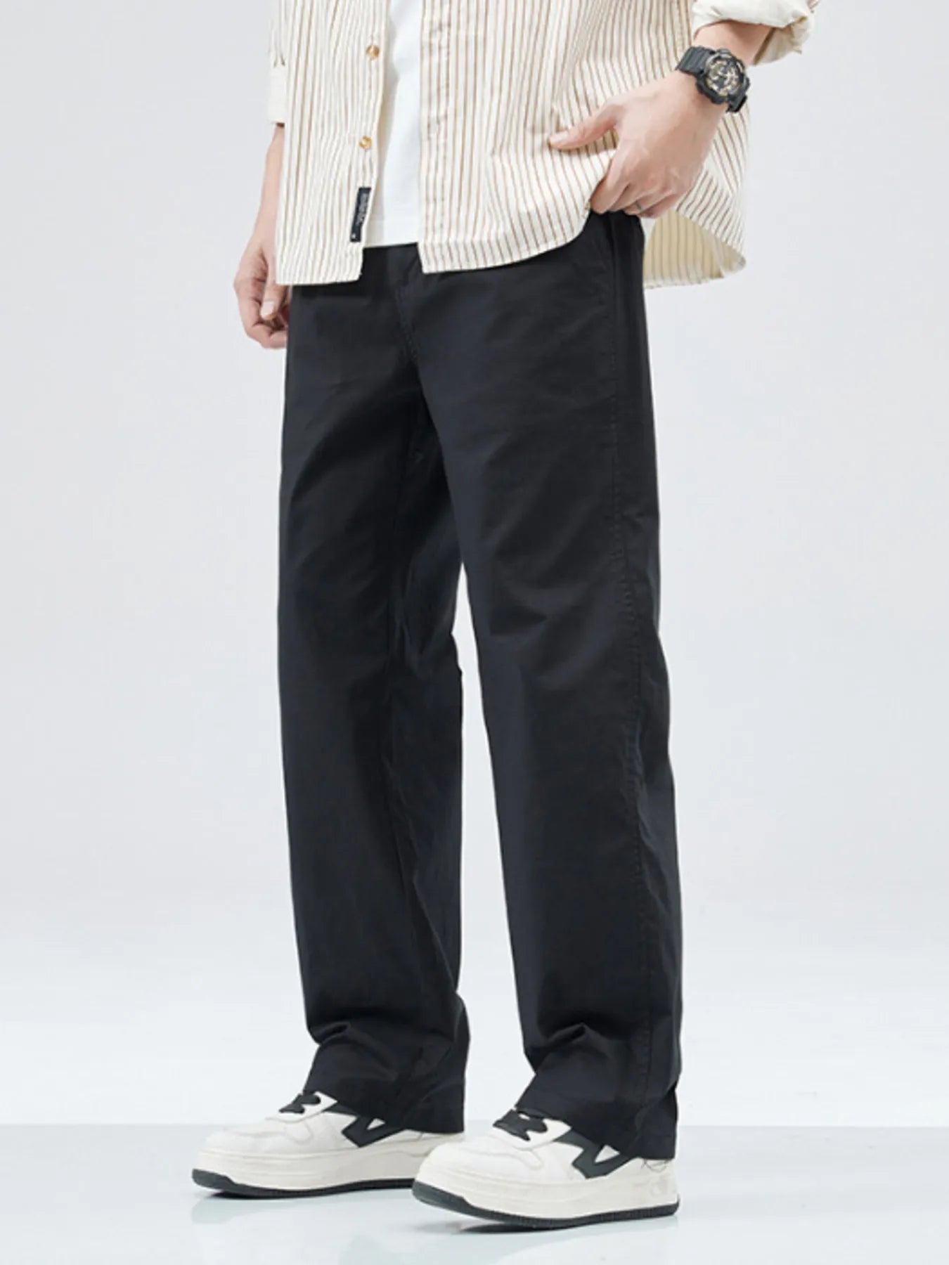 Black casual loose fit straight leg trousers with a relaxed cut.