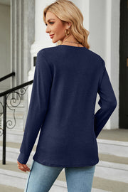 Dark blue waffle knit henley shirt with long sleeves and button placket detail.