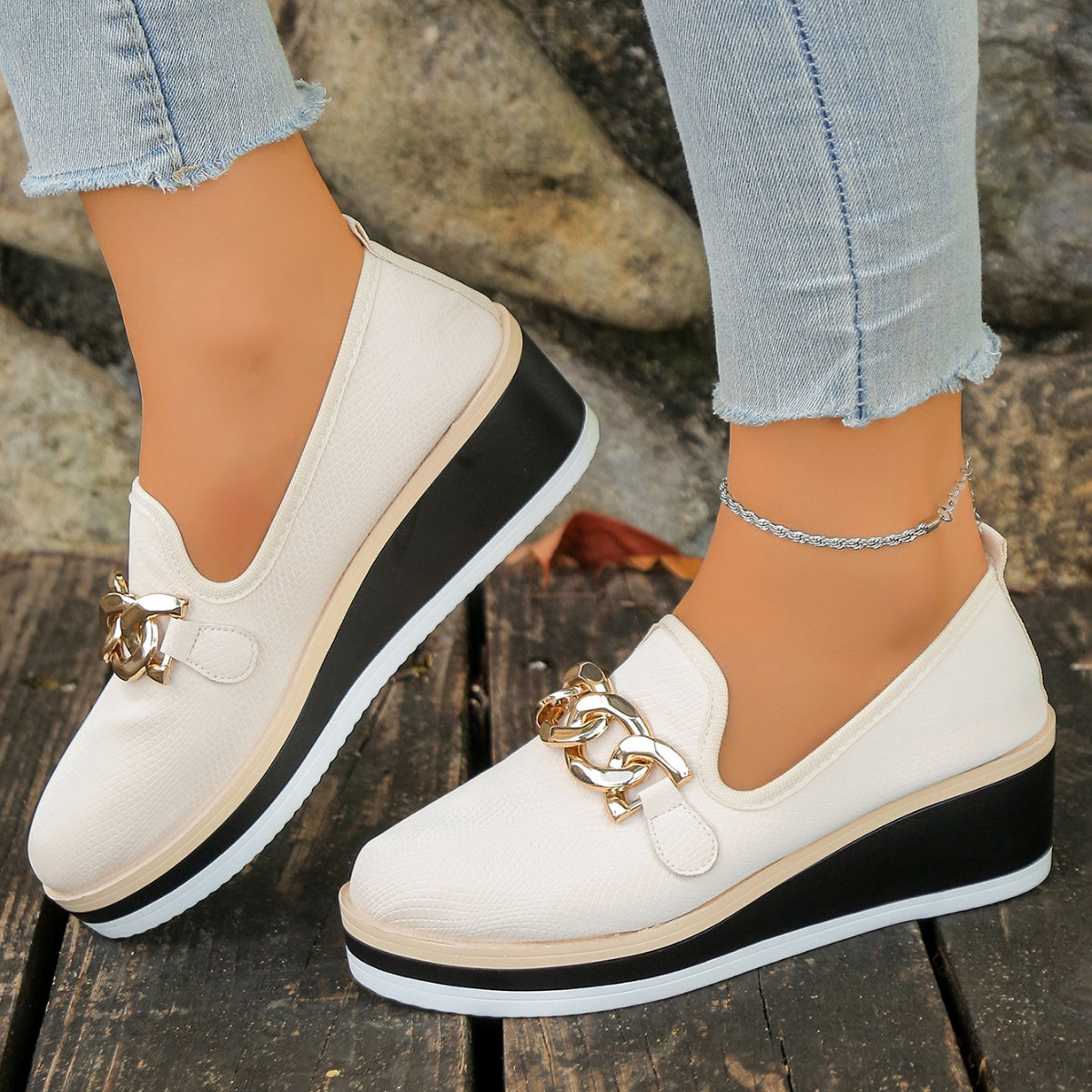 Beige chain decor wedge loafers with a textured finish and black platform sole.