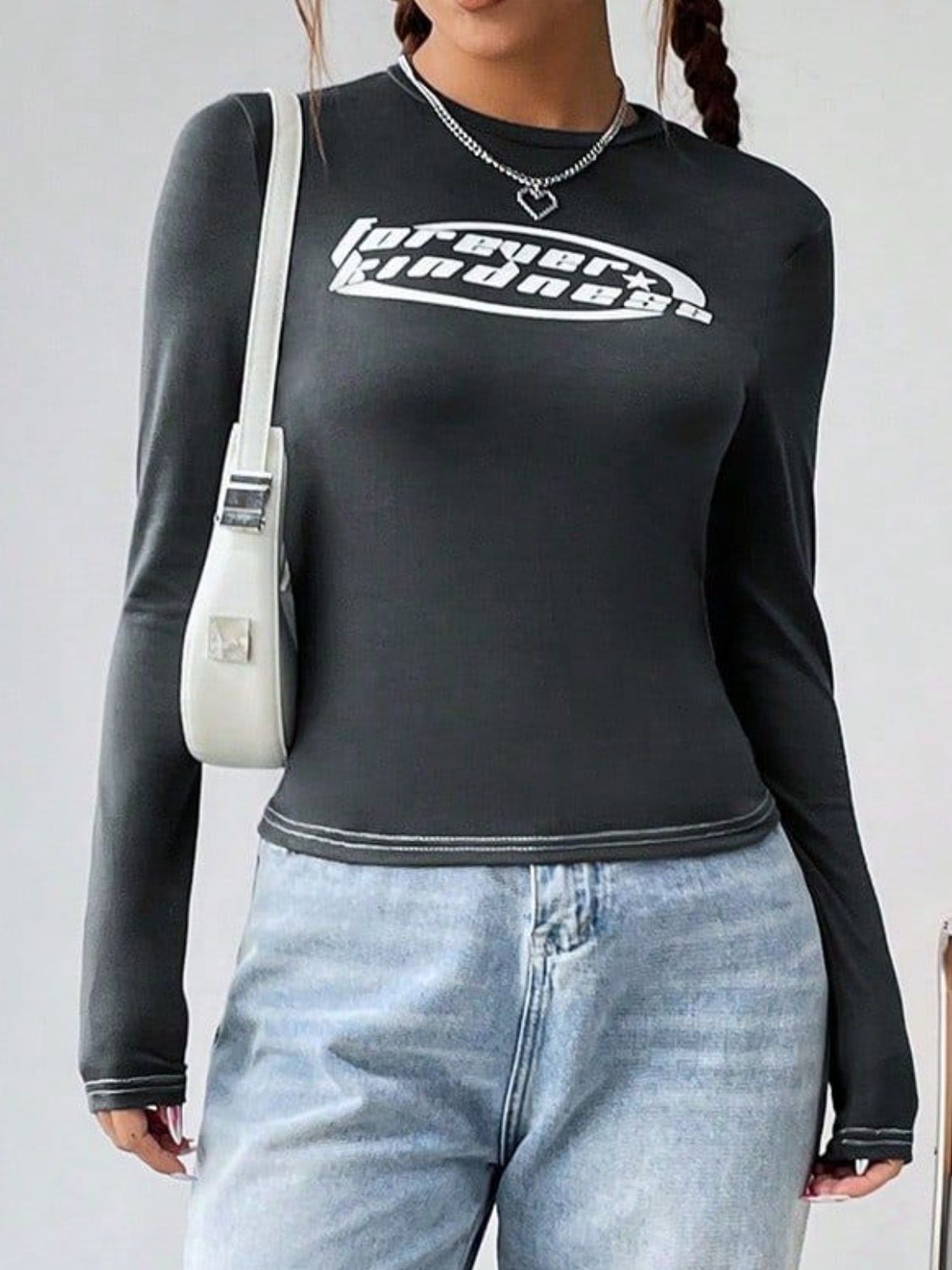 Dark gray fitted long sleeve top with white graphic and contrast stitching