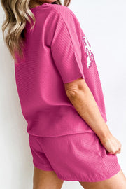 Fuchsia pink waffle knit loungewear set with "Mama" graphic on sleeve.