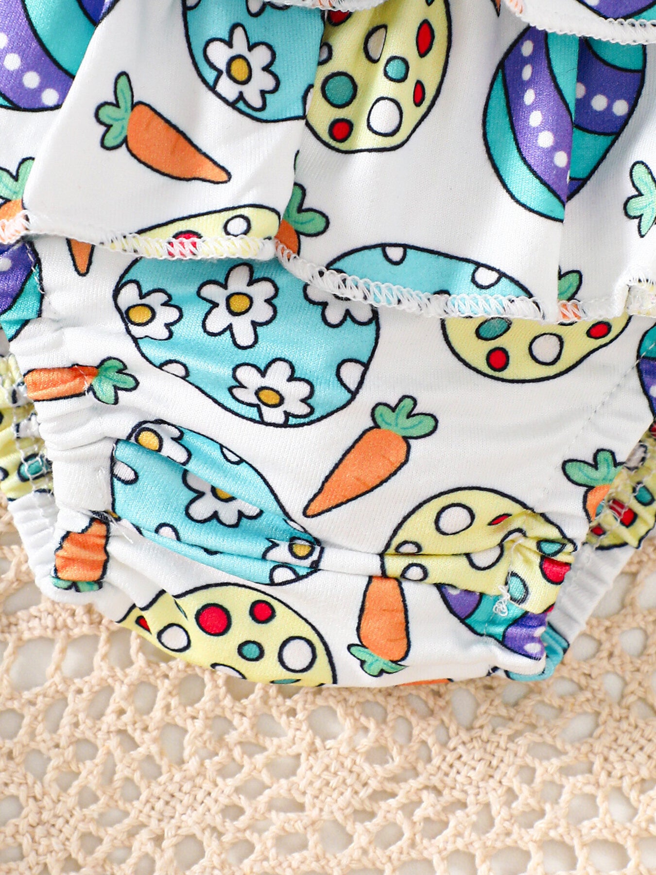 Baby bodysuit and skirt set with Easter egg and carrot print, white cotton with ruffles.