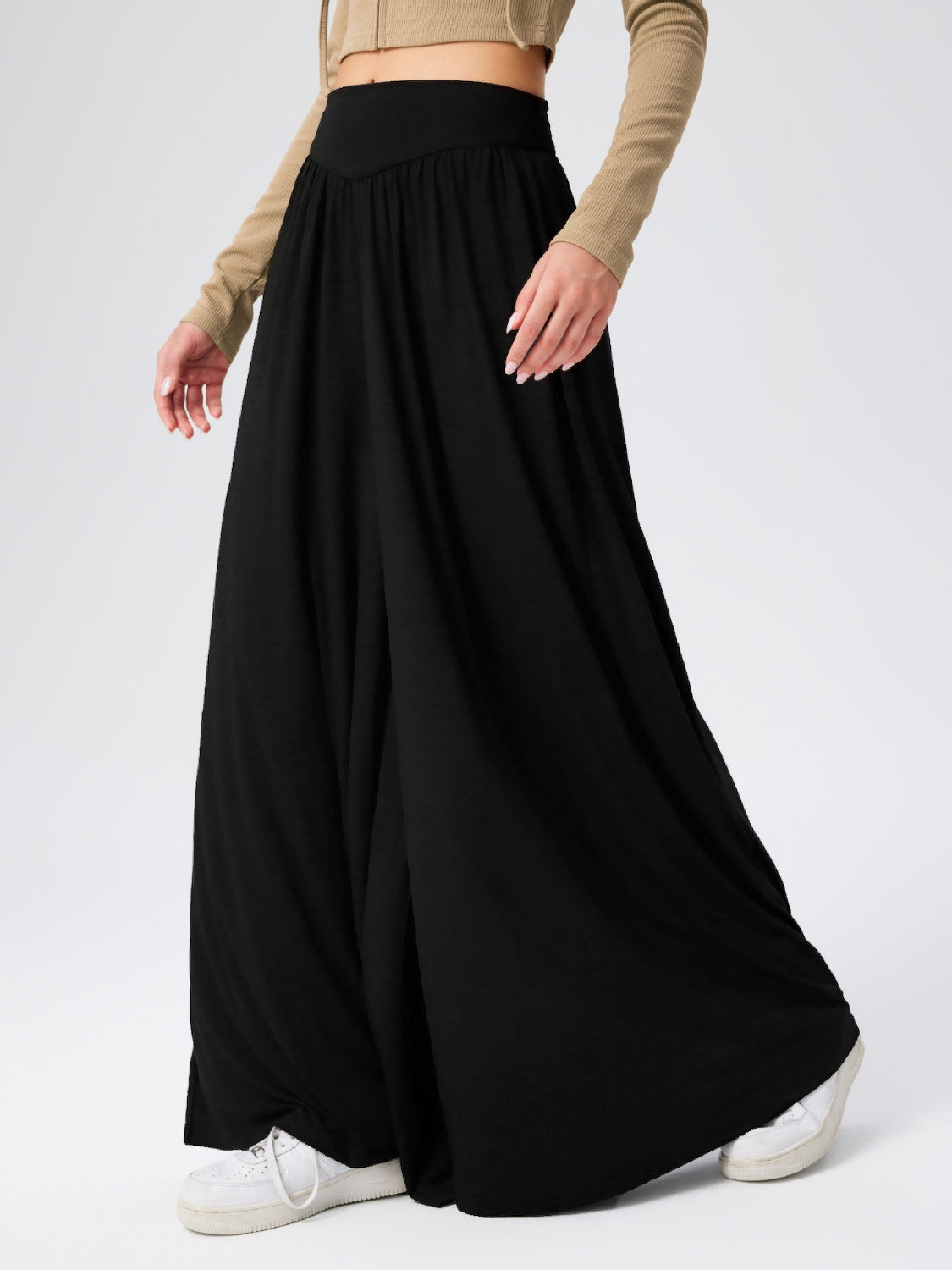 Black jersey wide-leg trousers with a drape-front detail and elasticated waistband.