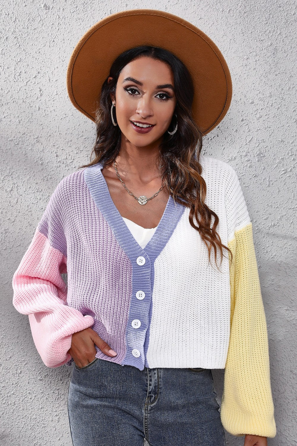 Colorblock knit cardigan with balloon sleeves, V-neck, button front, and pastel pink, purple, white, and yellow panels.