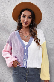 Colorblock knit cardigan with balloon sleeves, V-neck, button front, and pastel pink, purple, white, and yellow panels.