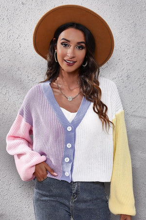 Colorblock knit cardigan with balloon sleeves, V-neck, button front, and pastel pink, purple, white, and yellow panels.