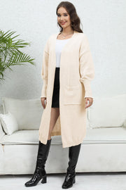Beige oversized pocketed knit cardigan with V-neck and long sleeves.