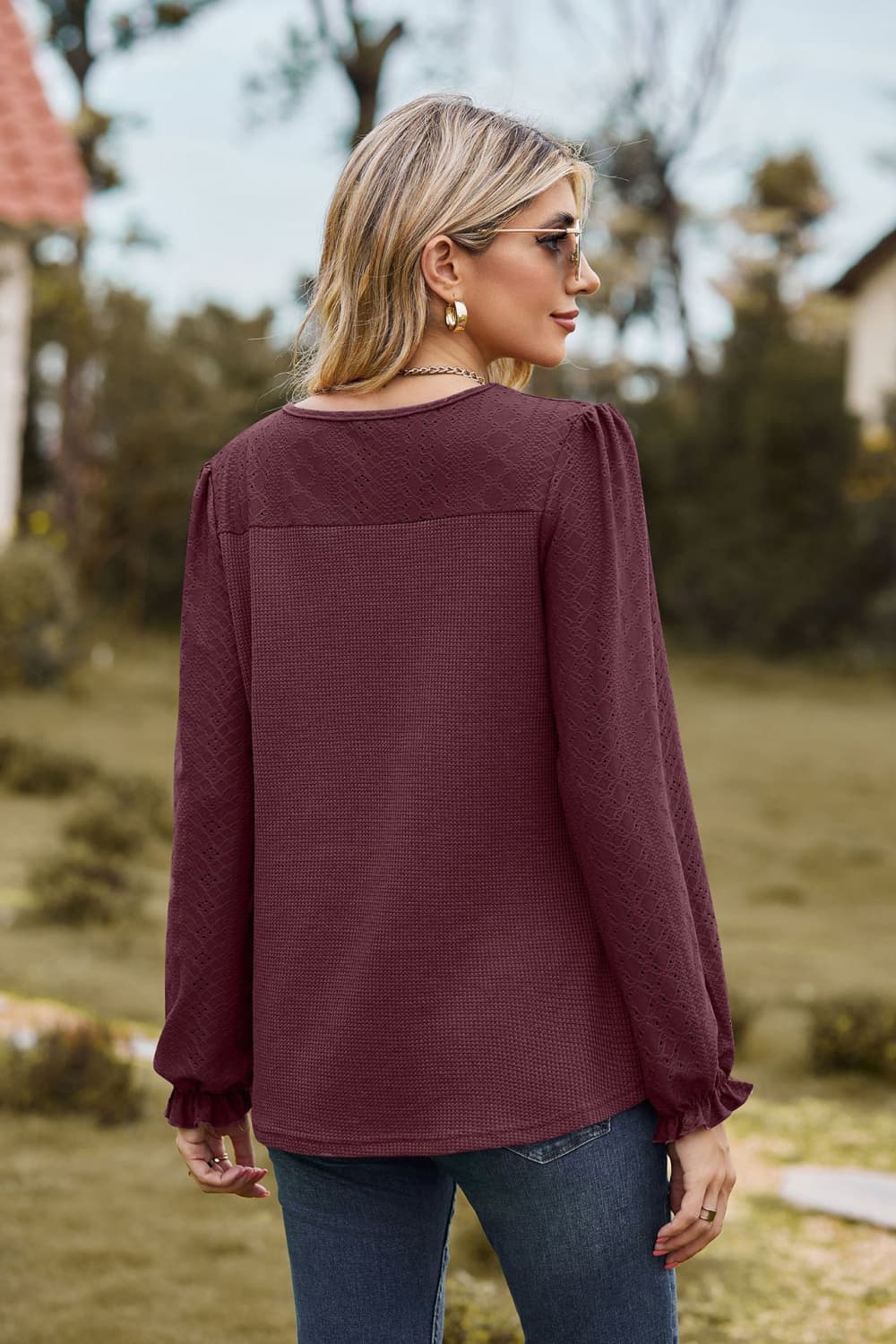 Burgundy waffle knit blouse with ruffle cuffs and perforated detail