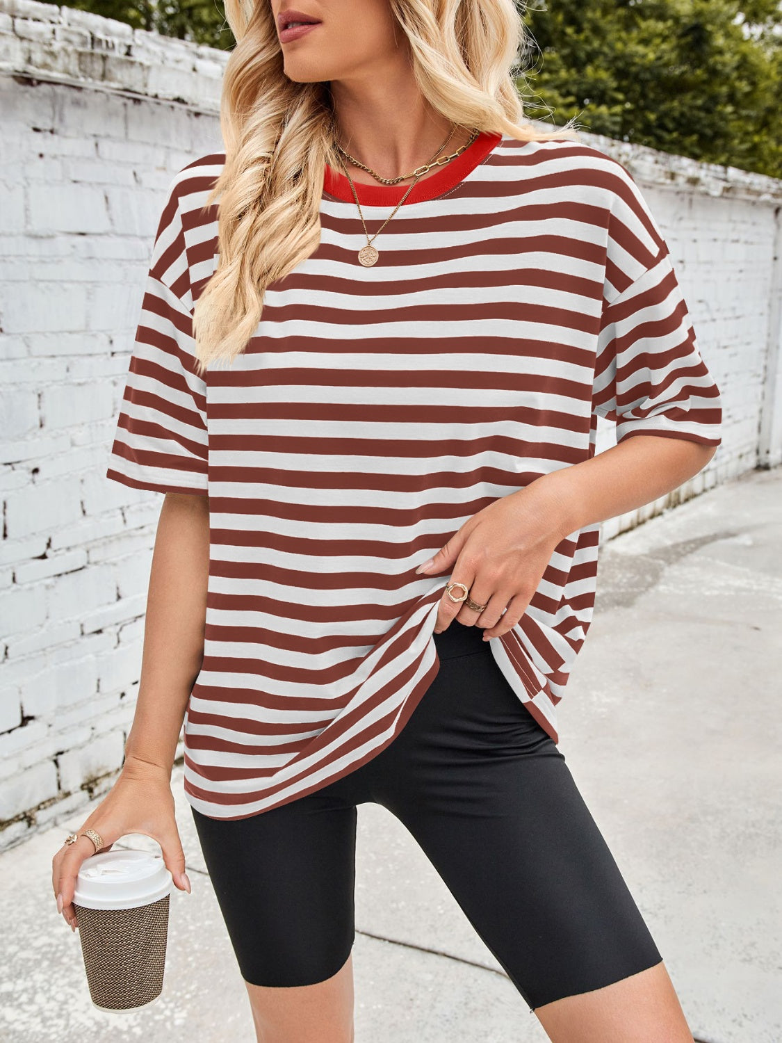 Brown and white striped relaxed tee with contrast red neckline and short sleeves.