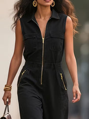 Black collared sleeveless zip-up romper with chest pockets and zippered side pockets.