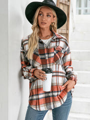 Oversized flannel shacket with patch pockets in orange plaid. Buttoned front, long sleeves.