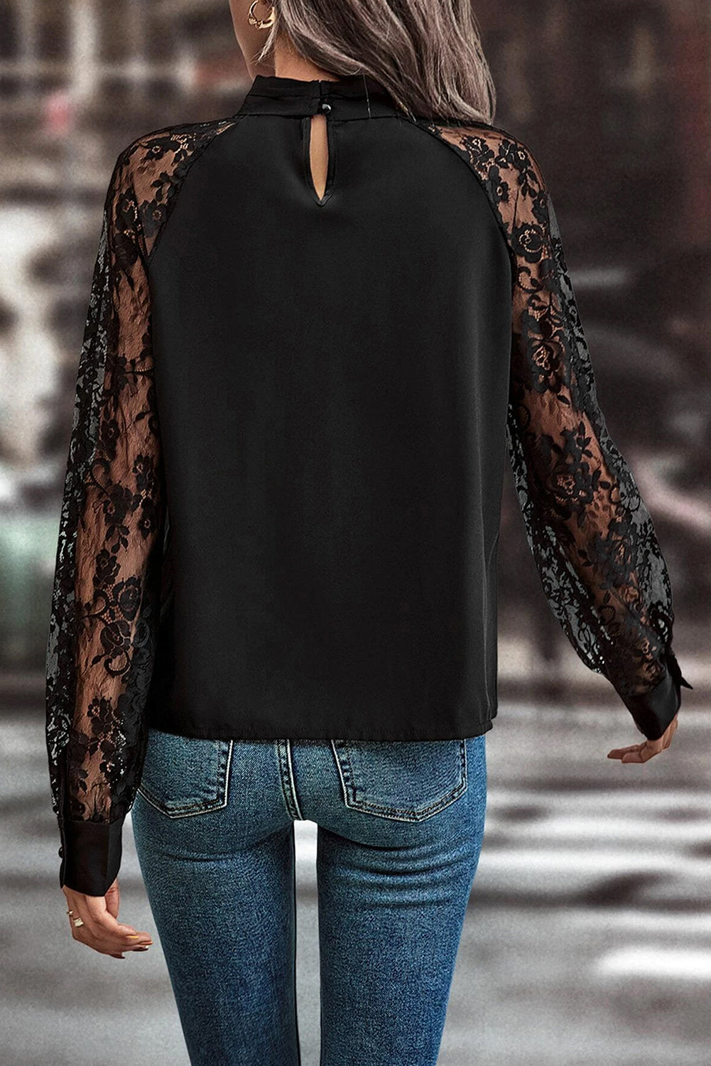 Black lace sleeve blouse with keyhole neckline and button closure at back neck.
