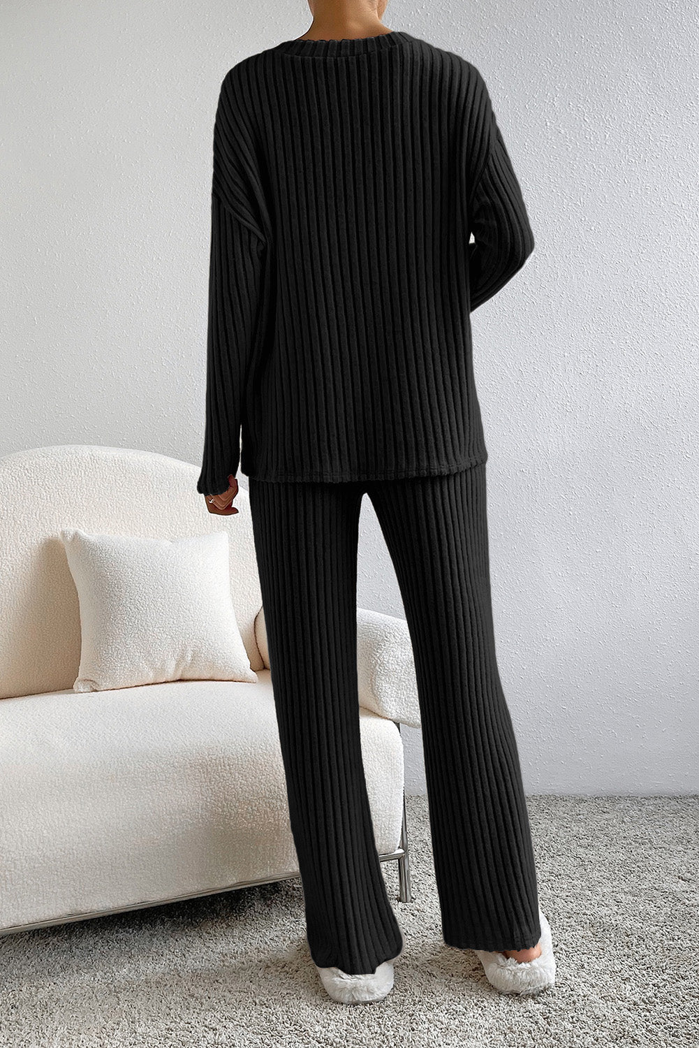 Black ribbed knit loungewear set with wide-leg pants and long-sleeve top.