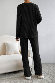 Black ribbed knit loungewear set with wide-leg pants and long-sleeve top.